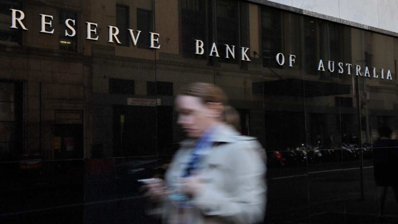 A pedestrian walks past the Reserve Bank of Australia