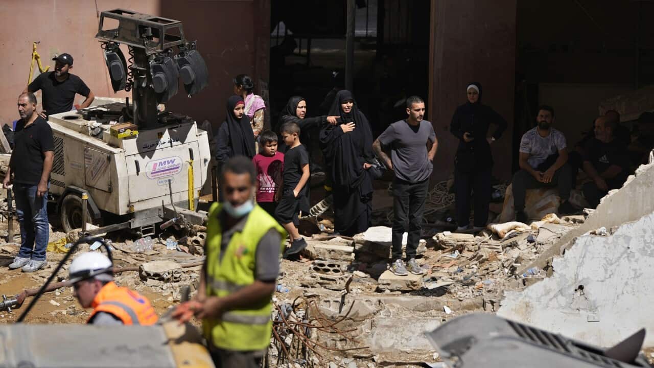 Rescuers search through rubble and building debris