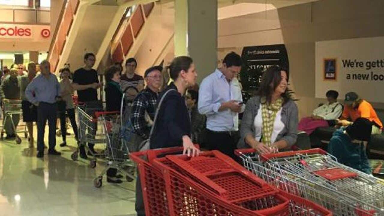 Shoppers queue at Aldi, Chatswood.