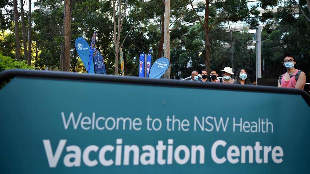 A queue forms outside at a mass COVID-19 vaccination hub in Sydney, Monday, May 10, 2021. The hub will be open to people in categories 1a and 1b before expanding to anyone over 50 from May 24. (AAP Image/Joel Carrett) NO ARCHIVING