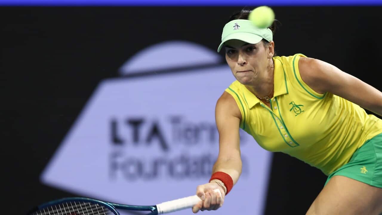 Ajla Tomljanovic of Australia prepares to hit the tennis ball with her racquet.