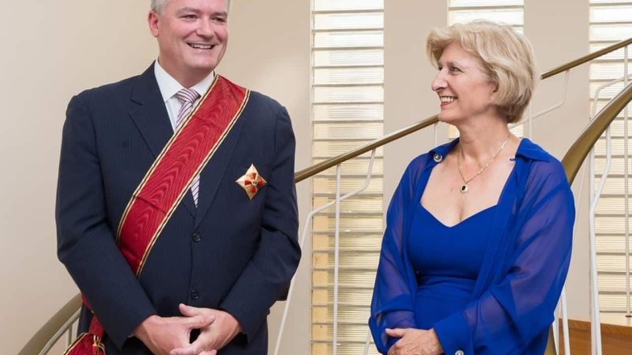 Mathias Cormann receives and award from Ambassador Dr Anna Prinz.