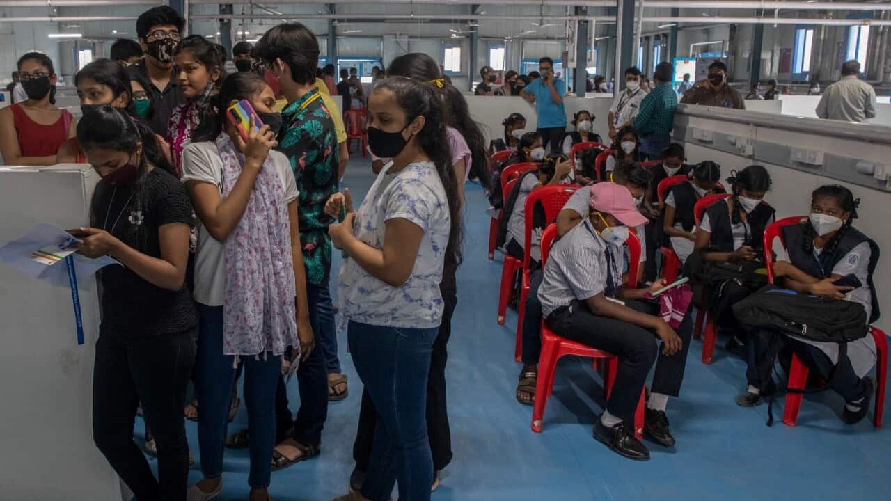 Indian teens wait to receive vaccination for COVID-19 at a vaccination center in Mumbai. (file)