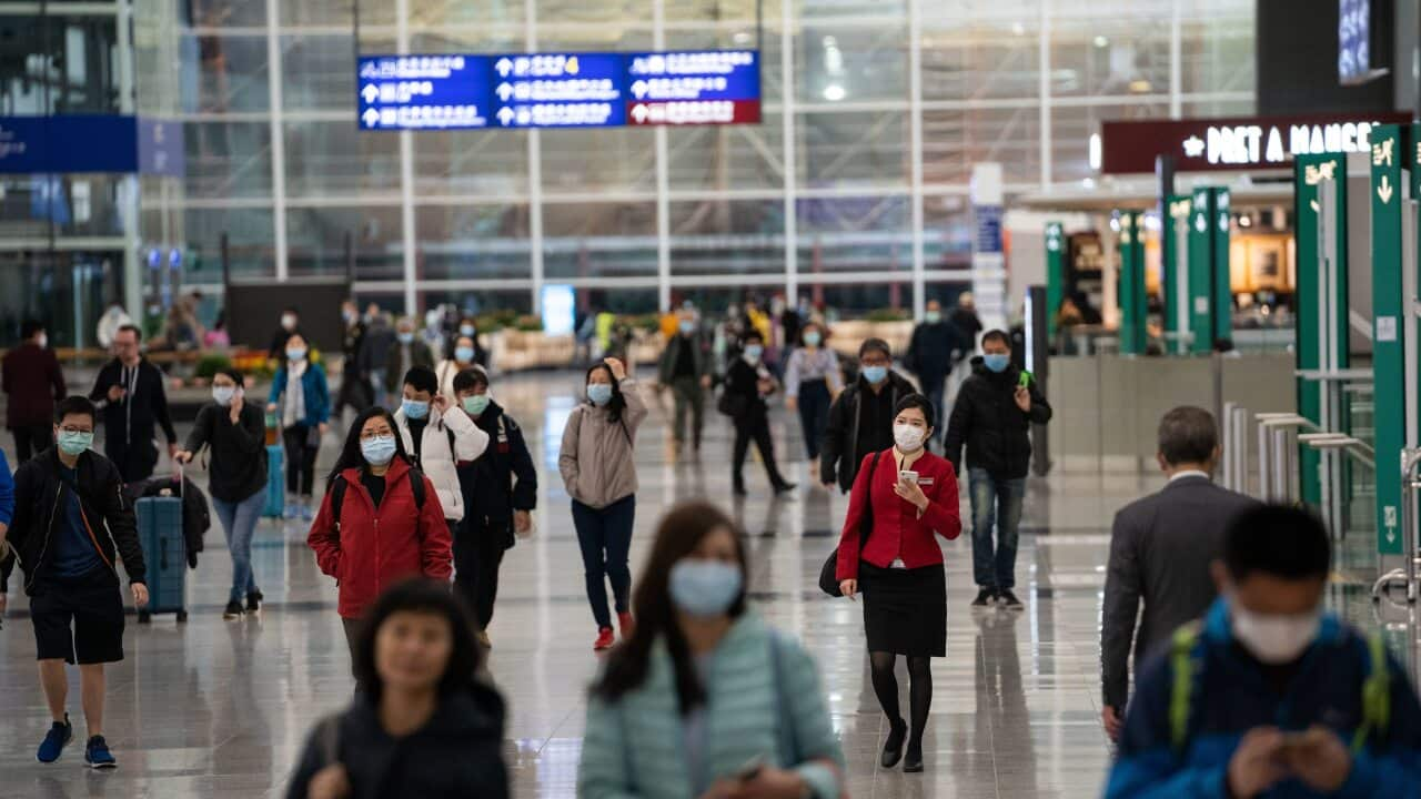 Travellers and airline crew members at the Hong Kong international airport