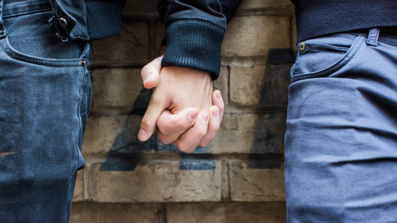 China, Hong Kong, close-up of gay couple holding hands