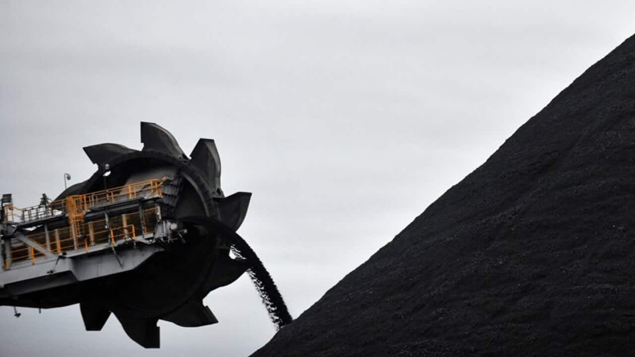 A loader shifts coal