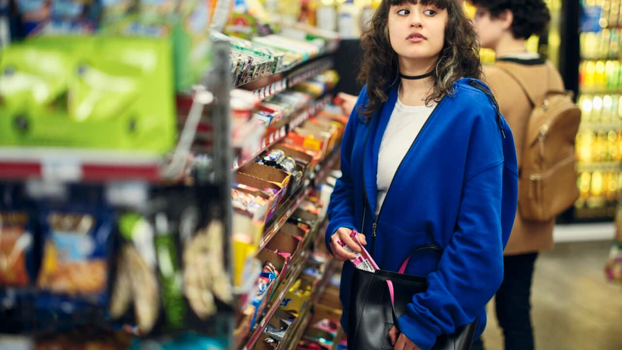 Young Woman Shoplifting in a Convenience Store