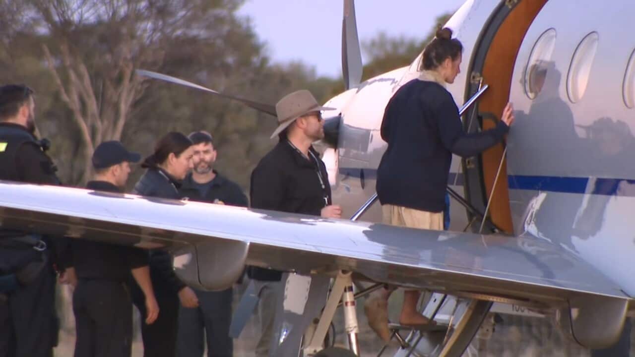 A screenshot taken from an ABC TV video shows a woman boarding a small aircraft.