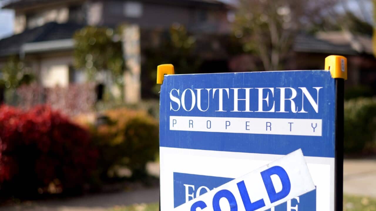 A sale sign is seen in front of a house in Canberra