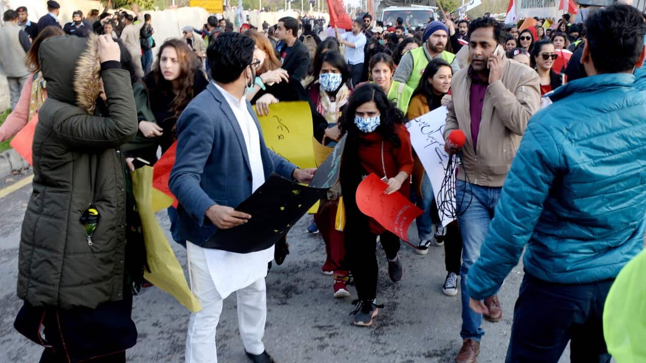 Activists of women rights run after clashes between two groups on International Women's Day in Pakistan