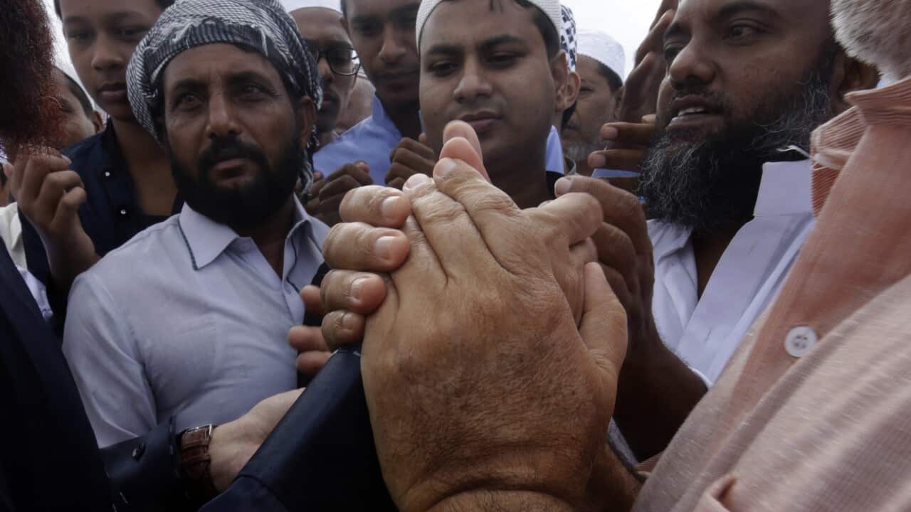Sri Lankan Muslims greet each other after Eid al-Adha prayers at the Galle Face Green in Colombo, Sri Lanka