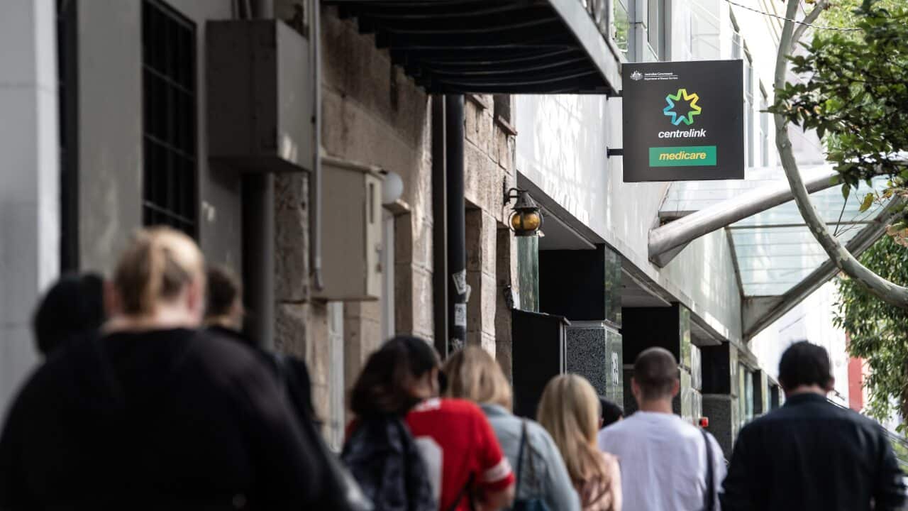 People queue for access to a Centrelink Service Centre in Sydney.