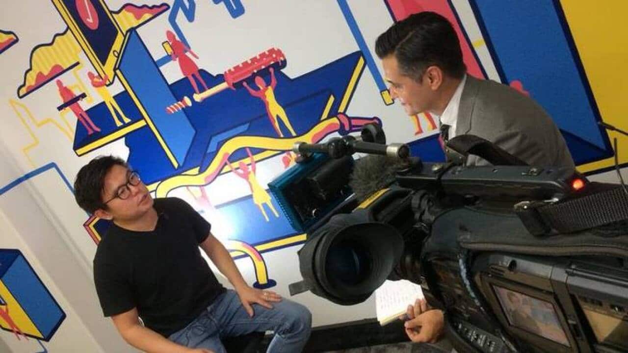 Airtasker co-founder Tim Fung (L) talks to Ricardo Goncalves