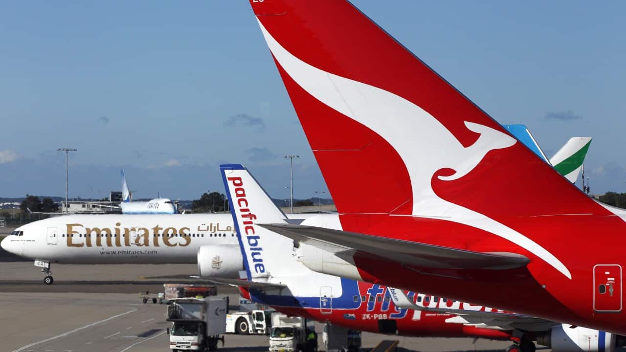 Qantas and Emirates planes on the tarmac.