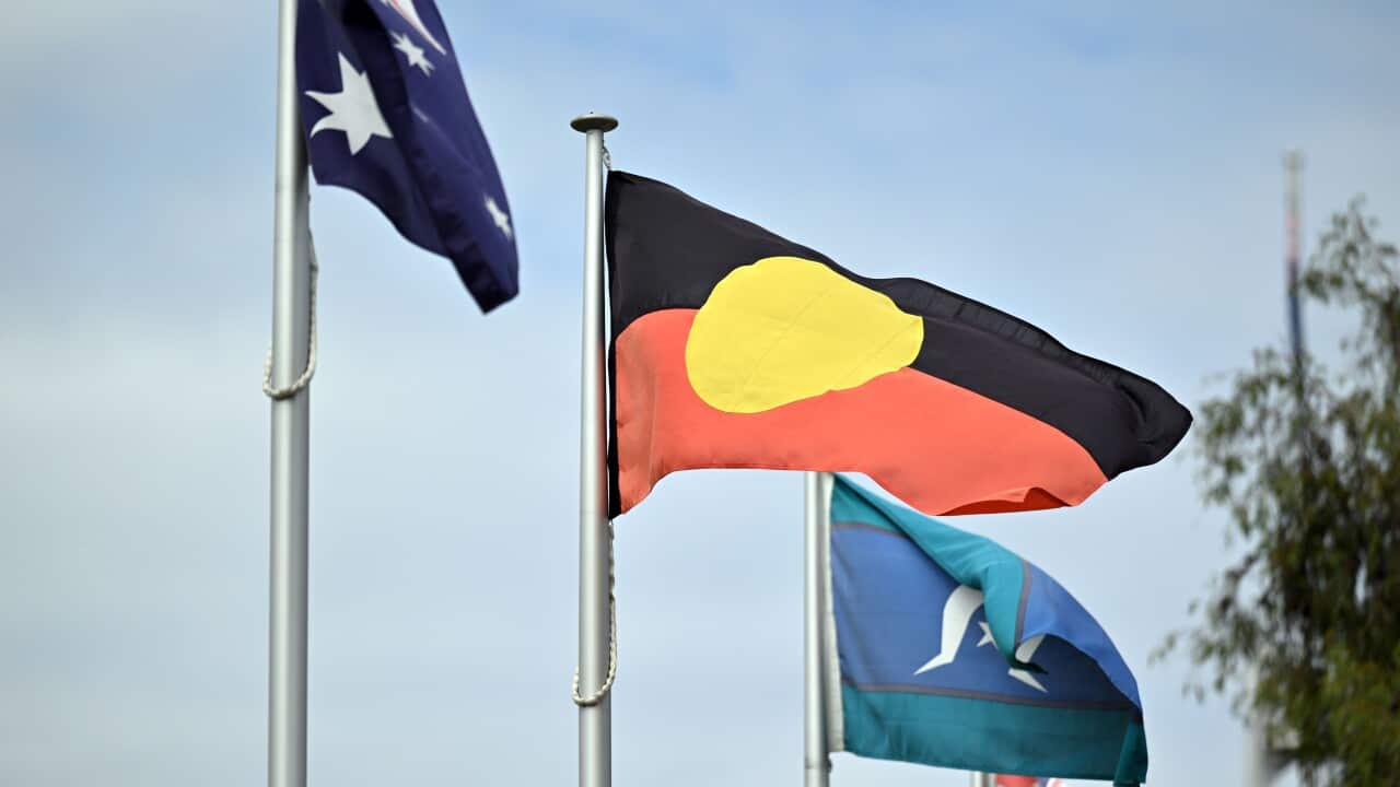 Australian and Aboriginal flags on poles.