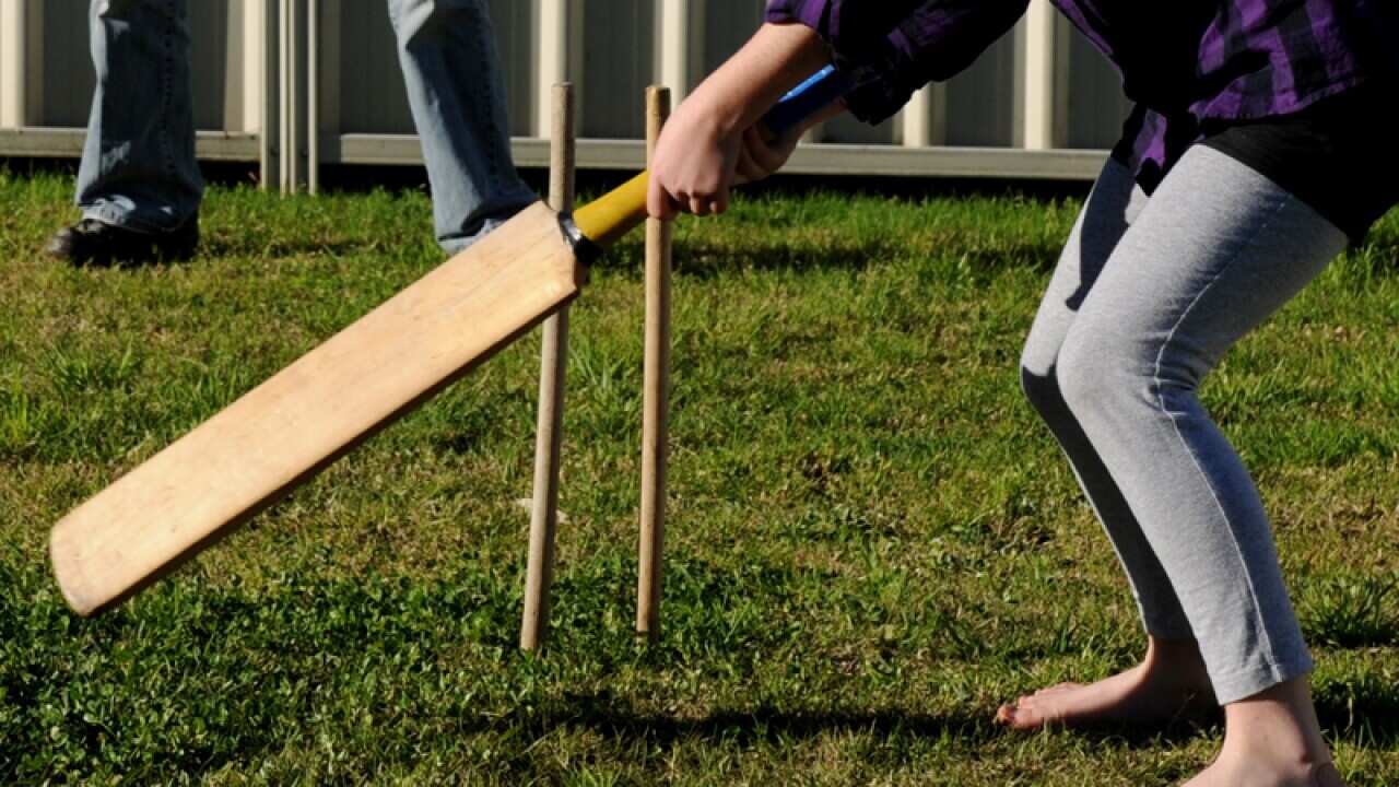 A child plays cricket