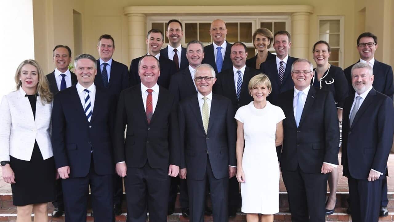 Australian Prime Minister Malcolm Turnbull (centre) poses for photographs with members of his new Cabinet.