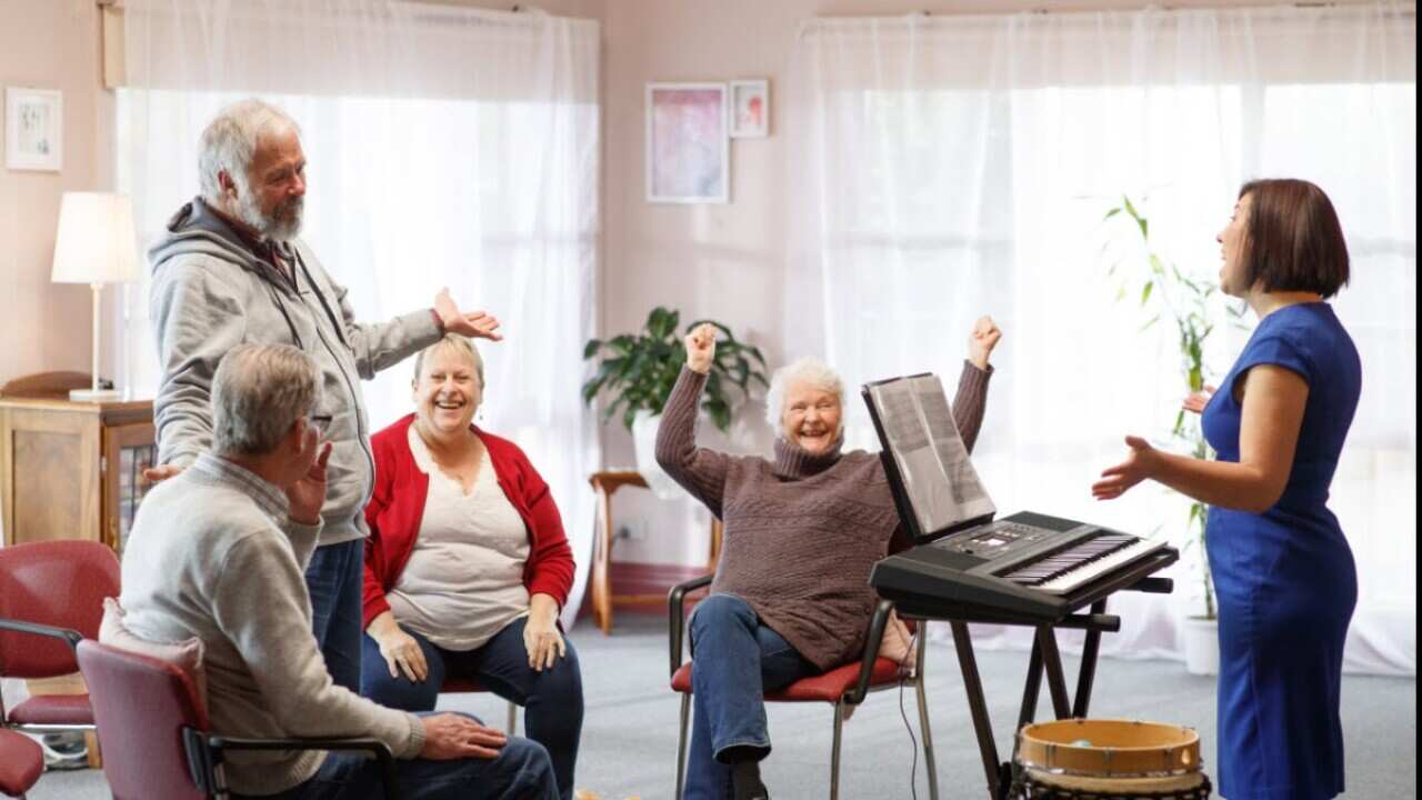 Professor Felicity Baker (R) runs a music therapy session to people living with dementia
