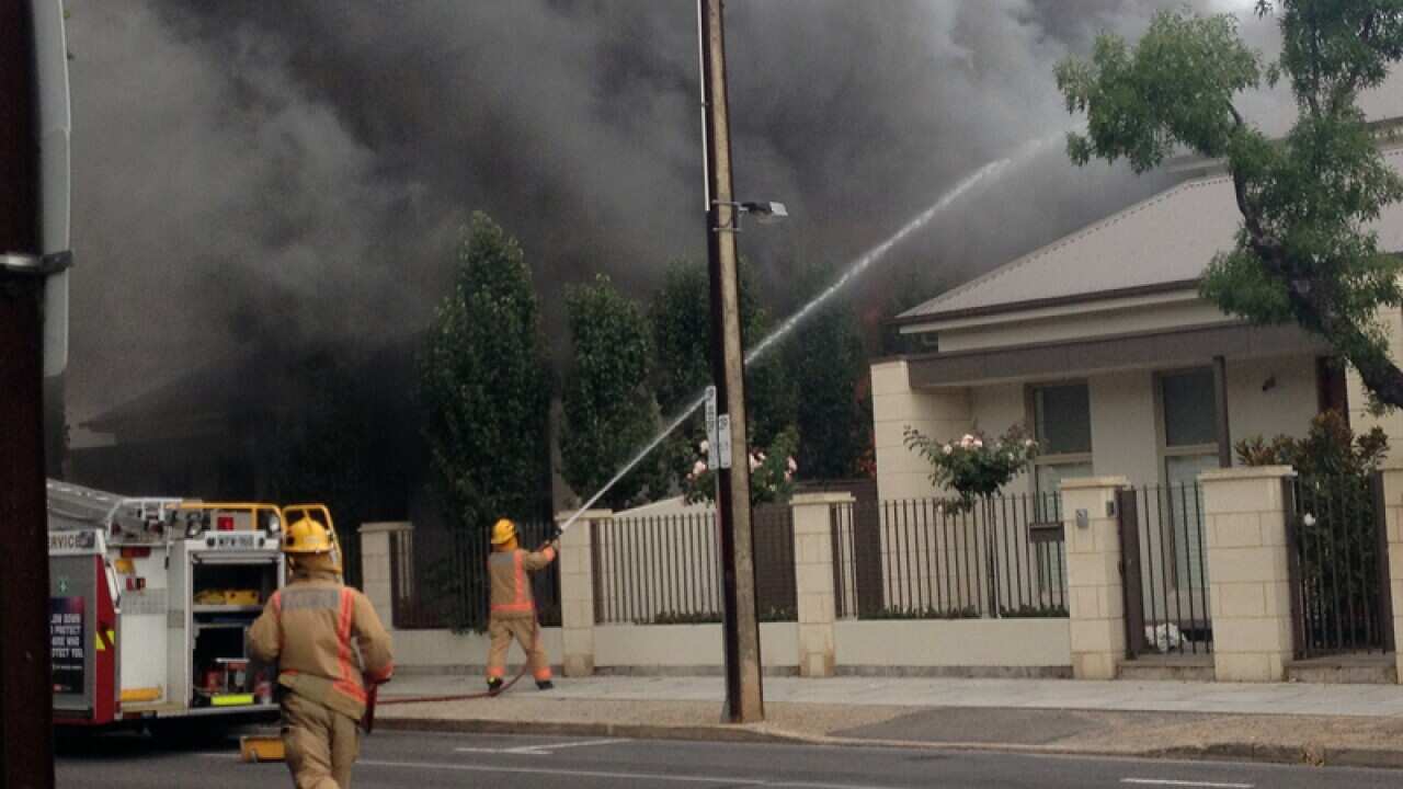 Firefighter battle a townhouse fire in North Adelaide