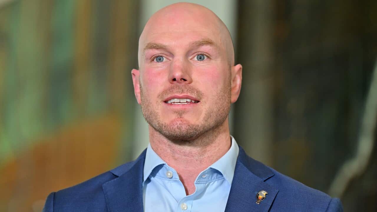 A man in a blue suit jacket and shirt