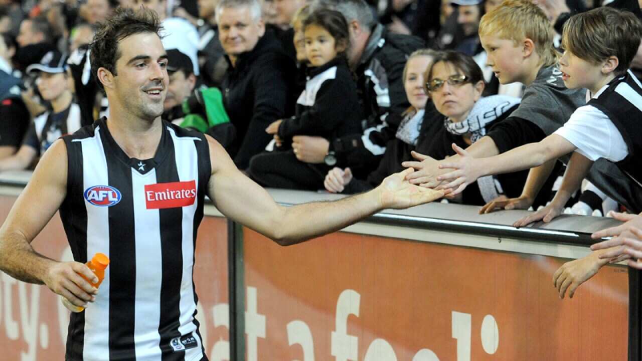 Steele Sidebottom of Collingwood celebrates with fans