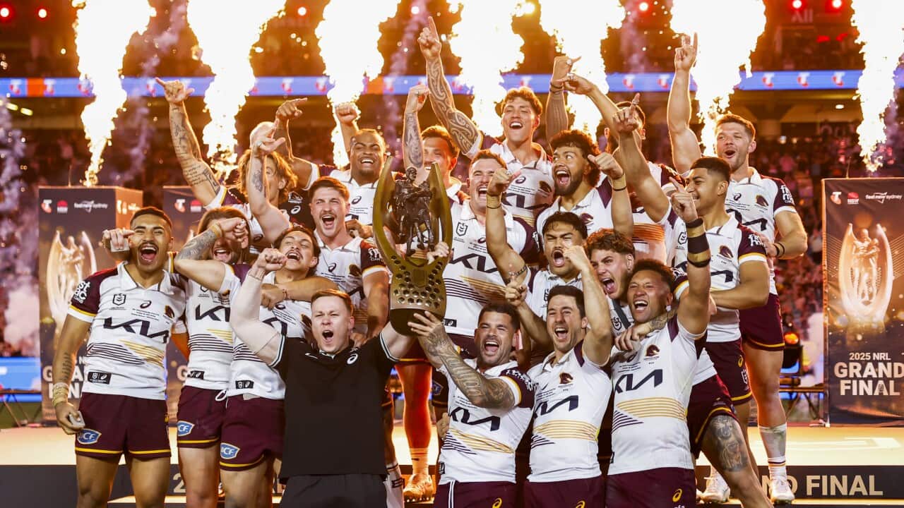 Broncos players hold aloft the Provan-Summons Trophy after winning the during the NRL Grand Final match between the Brisbane Broncos and the Melbourne Storm at Accor Stadium in Sydney, Sunday, October 5, 2025