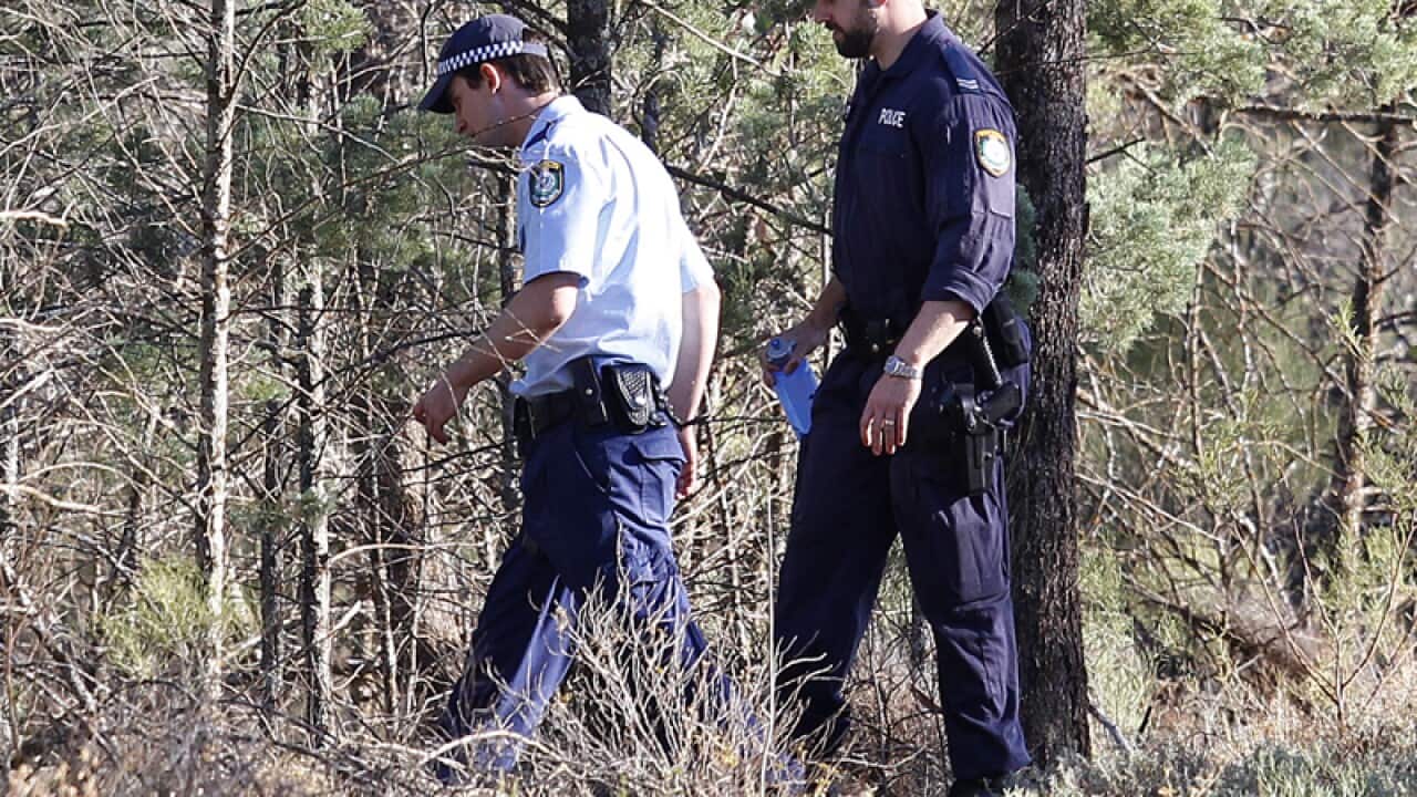 Police walk into bushes in Cocoparra National Park
