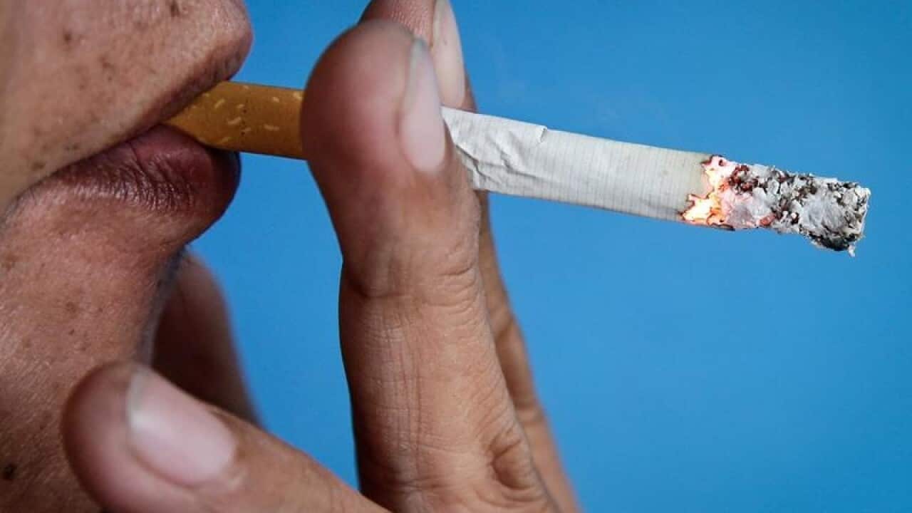 A man smokes a cigarette