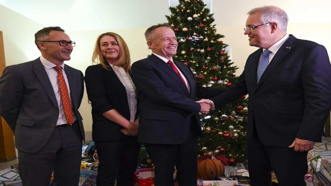 Bill Shorten (c) shakes hands with PM Scott Morrison