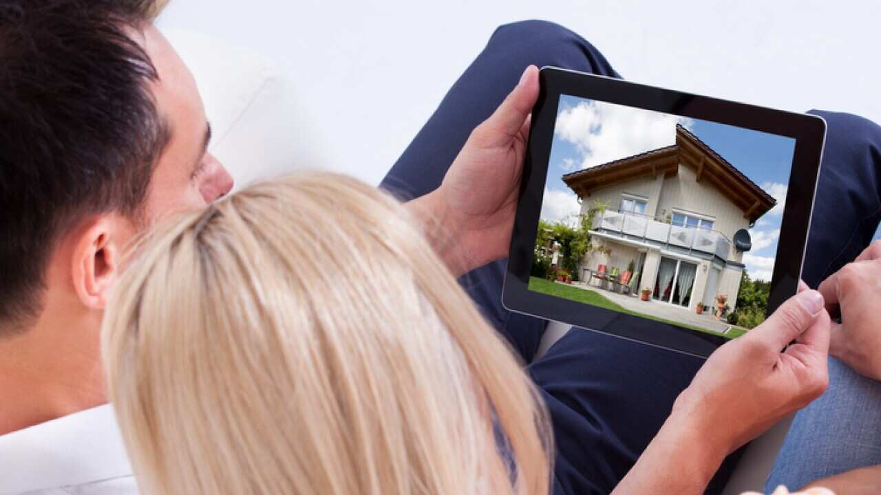 Couple Looking At Digital Tablet