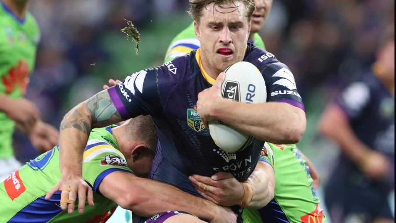 Cameron Munster scores for the Storm against the Raiders.