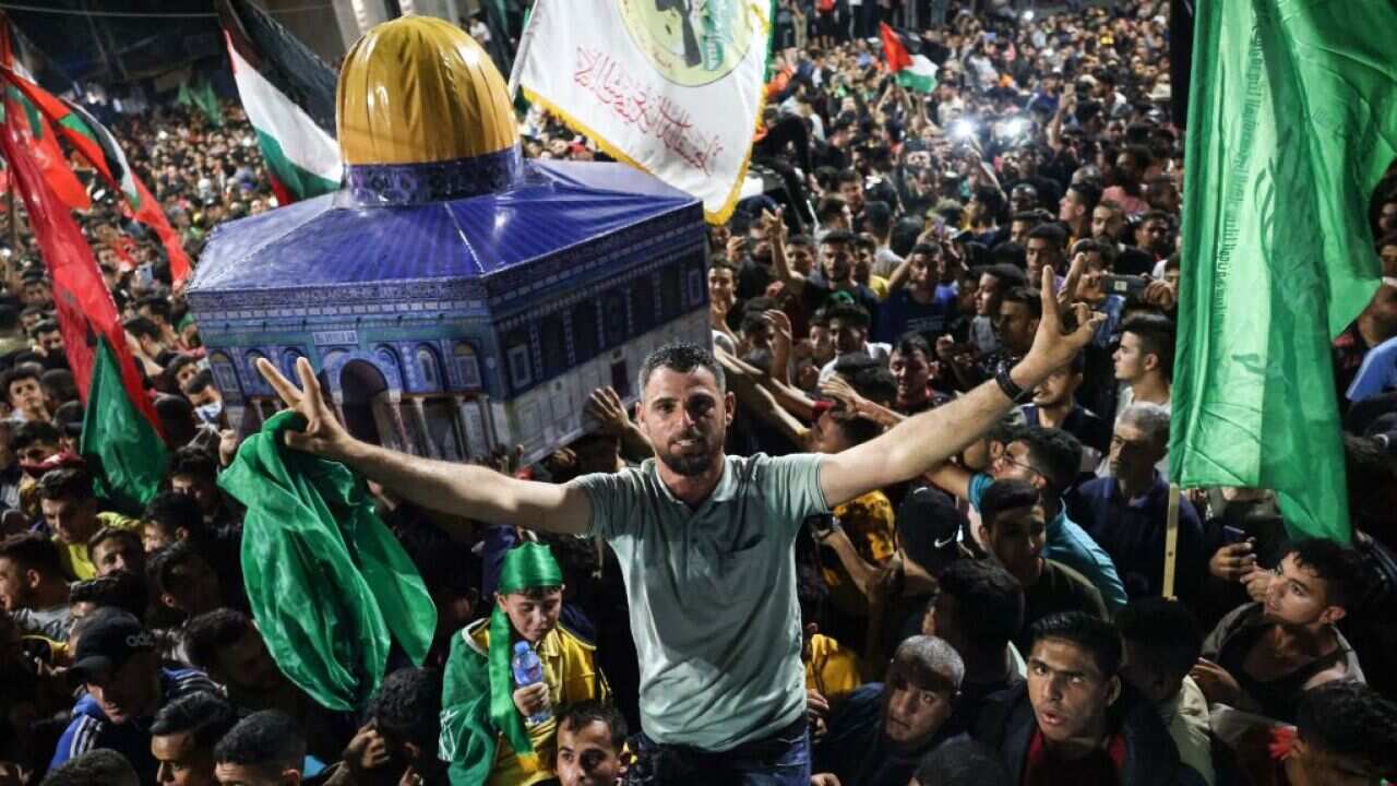 People celebrate in the streets of Gaza following a ceasefire brokered by Egypt between Israel and Palestinian groups.