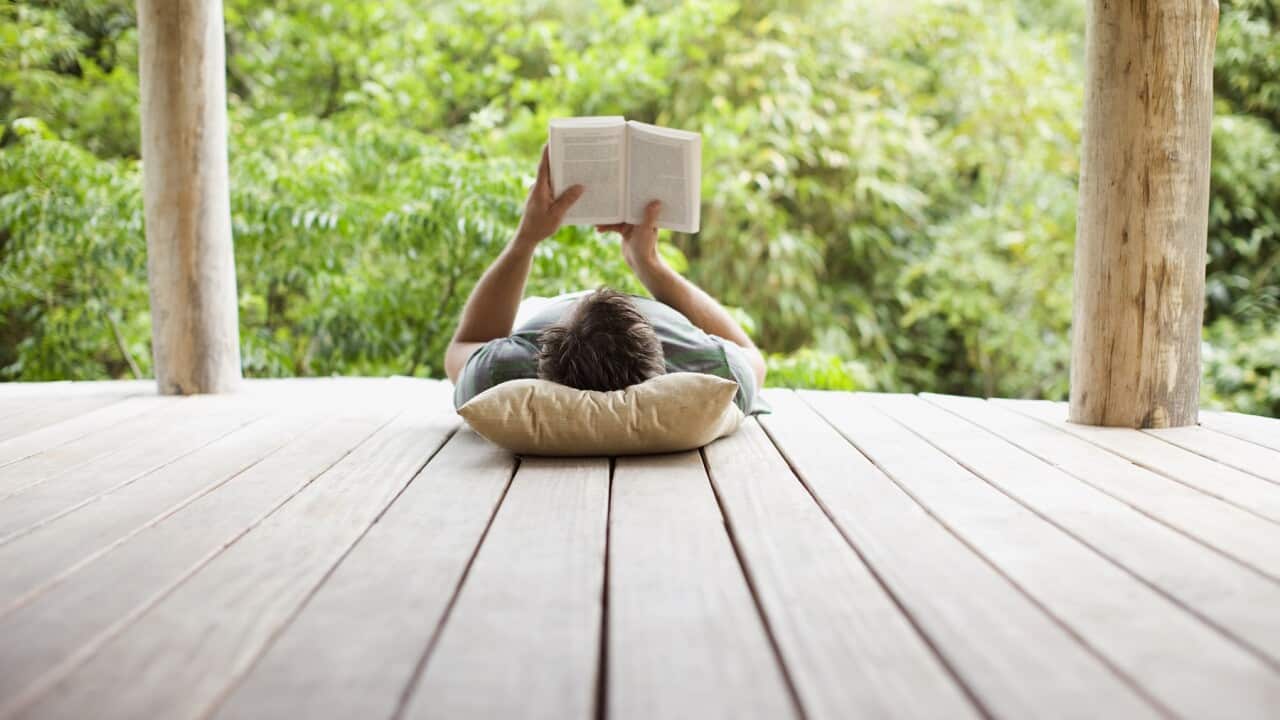 Man reading on porch in remote area
