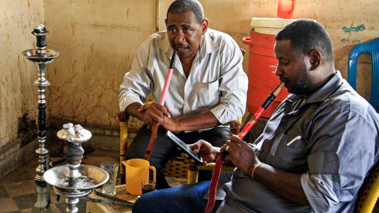 Men smoke shisha (also known as hookah) at a cafe in the Sudanese capital Khartoum