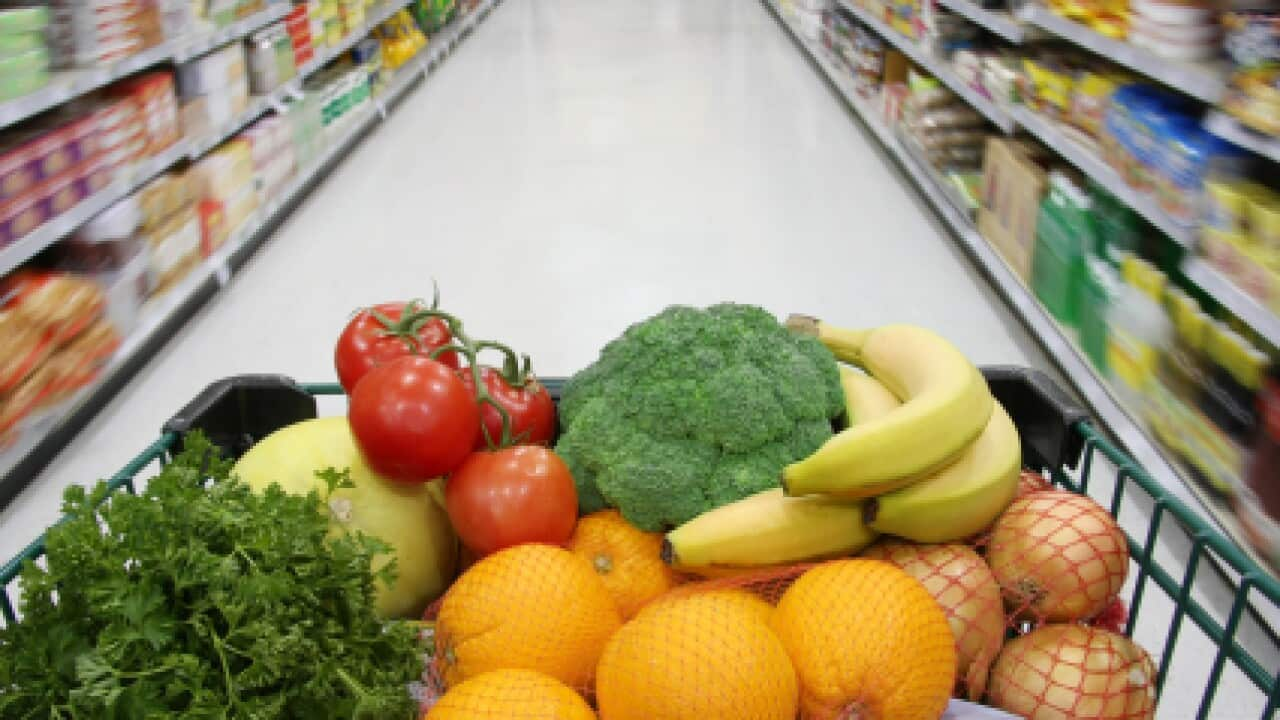 Grocery cart filled with nutritious fruits and vegetables. 