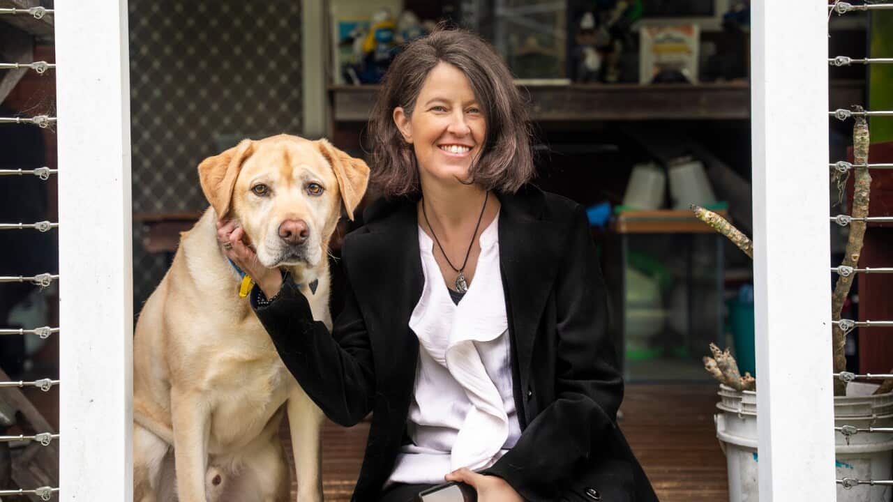 Jess Harper relies on with mobility assist dog Elvis to maintain balance when she walks (SBS -Spencer Austad).jpg