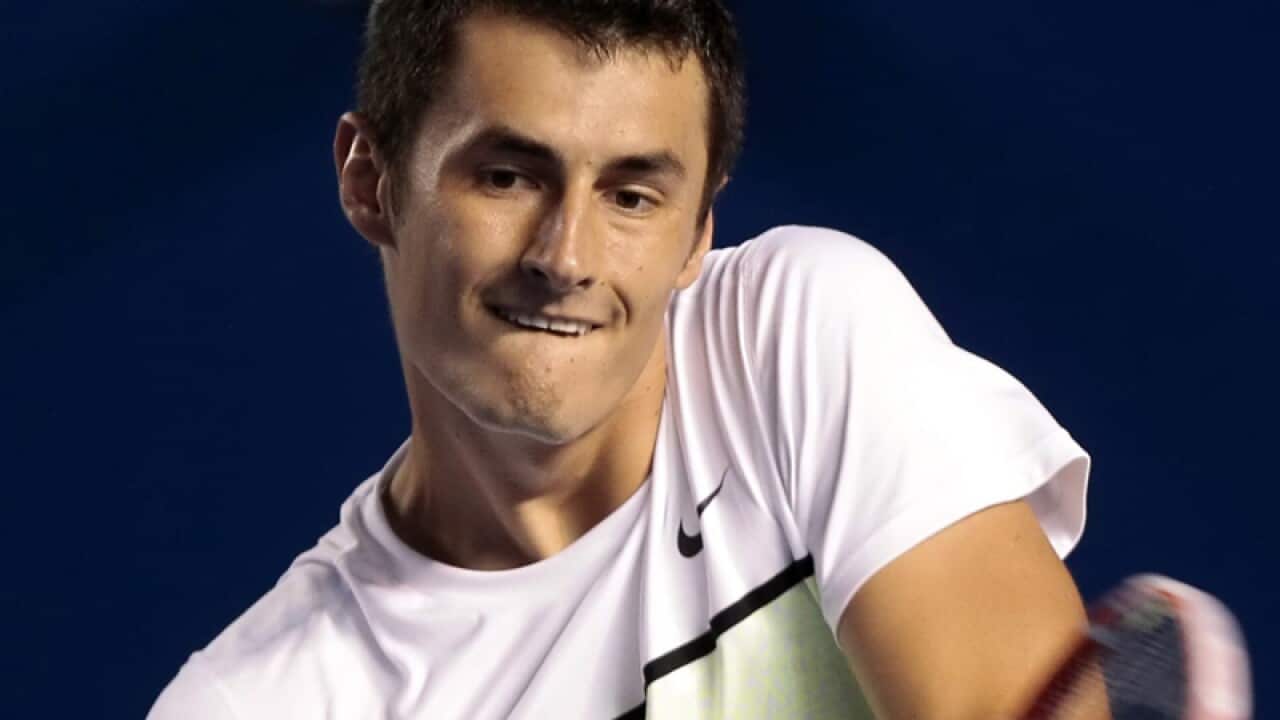 Bernard Tomic of Australia in action against David Ferrer