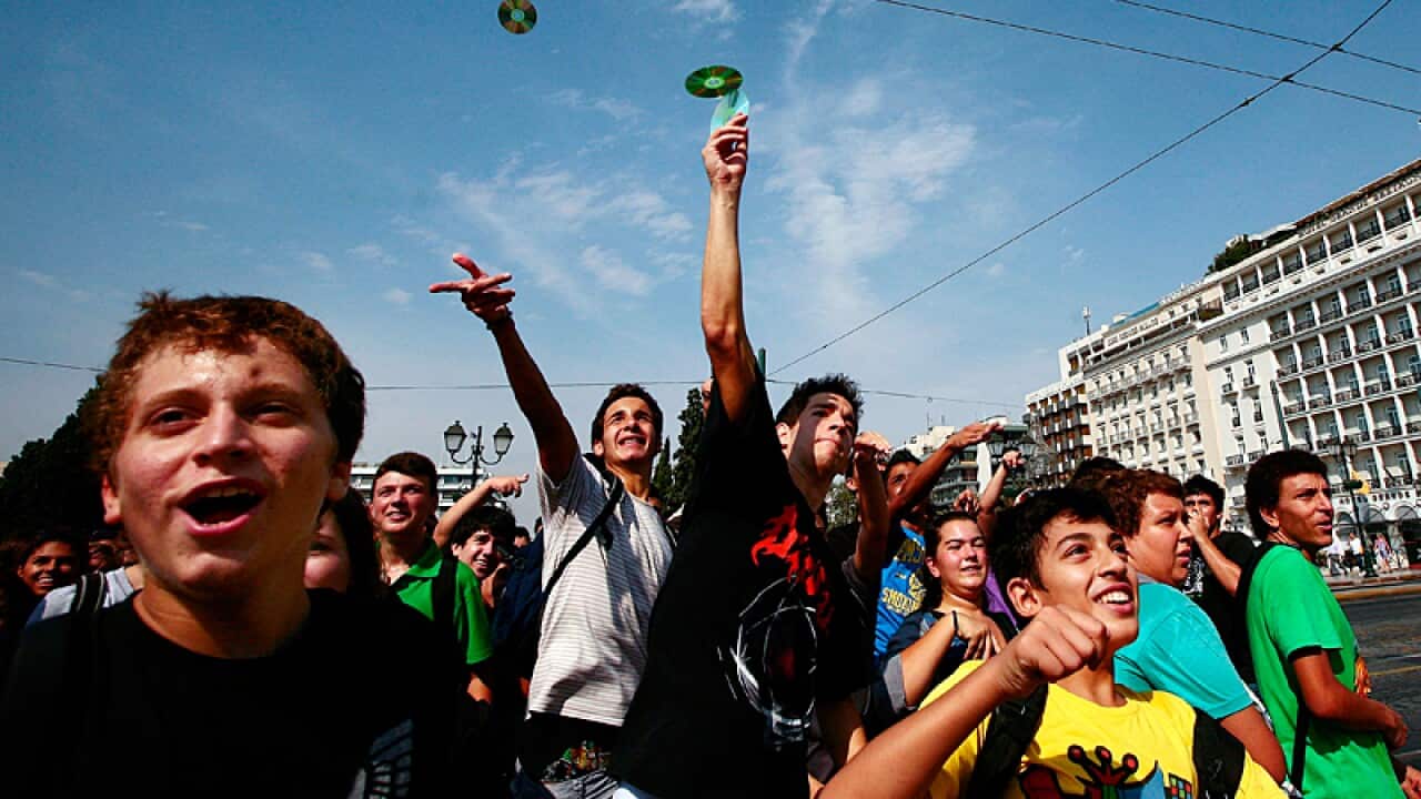 Students throw educational CDs distributed by the Greek Ministry of Education at the Greek Parliament during a students' protest in Athens. (EPA)