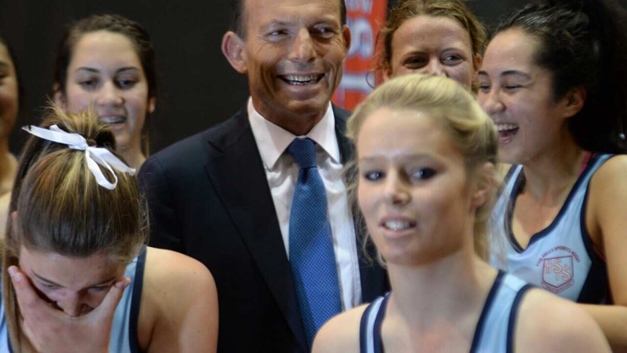 Opposition Leader Tony Abbott poses with netballers in Sydney