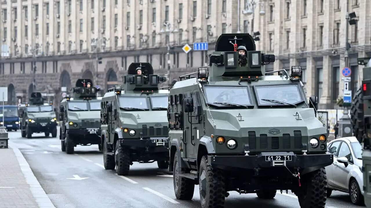 Ukrainian military vehicles move past Independence square in central Kyiv as cities across Ukraine were hit with what Ukrainian officials said were Russian missile strikes and artillery on 24 February, 2022.