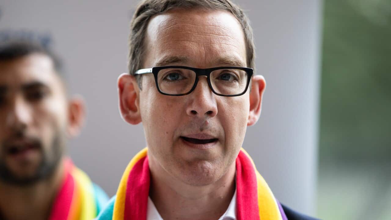 Victoria's Creative Industries Minister Steve Dimopoulos wearing a rainbow scarf
