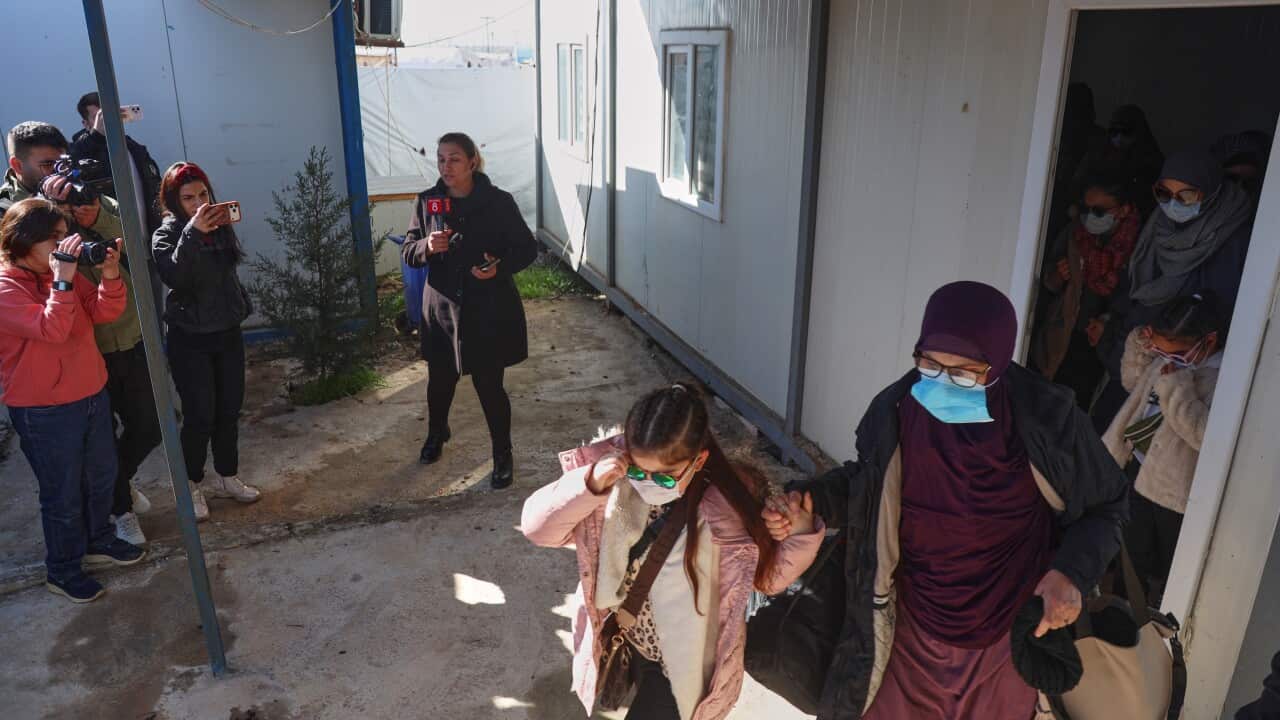A group of Muslim women and children leaving a camp