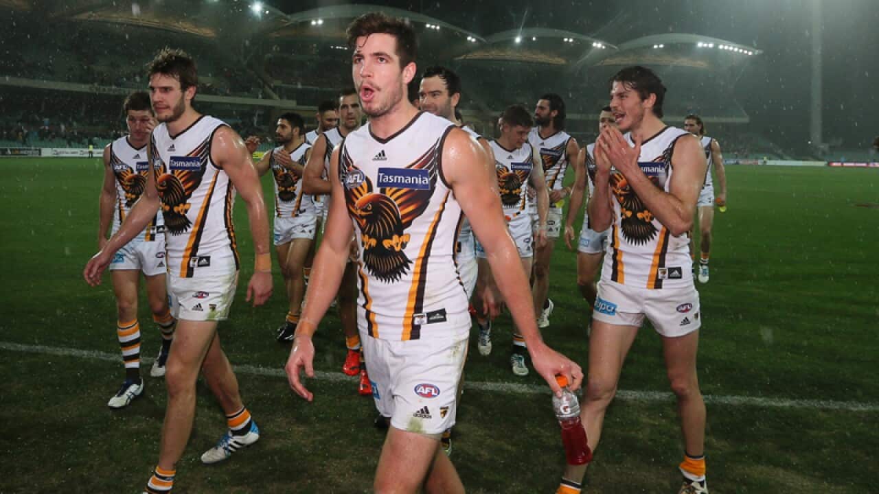 Hawthorn players leave a wet Adelaide Oval victorious