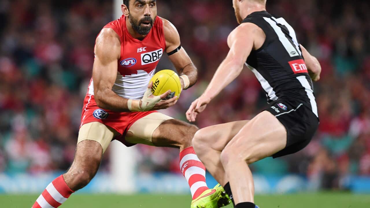 Adam Goodes of the Swans avoids Jonathon Marsh of the Magpies.