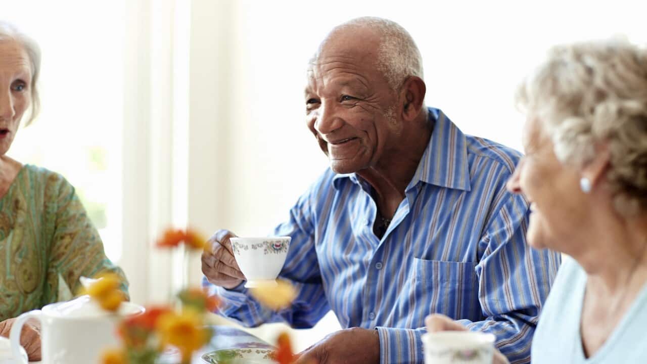 Senior man having coffee with friends