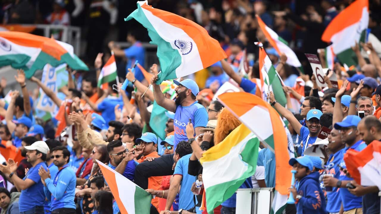 Supporters cheering the Indian cricket team.