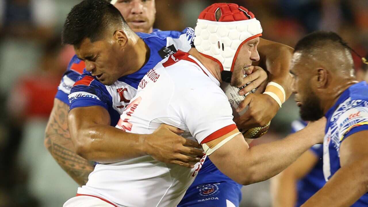 Chris Hill of England is tackled