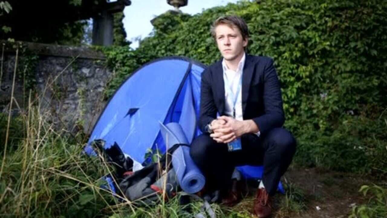 New Zealander David Hyde next to his tent and backpack.
