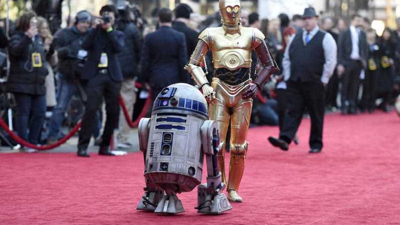 Film characters R2-D2, left, and C-3PO arrive at the world premiere of "Star Wars: The Force Awakens".