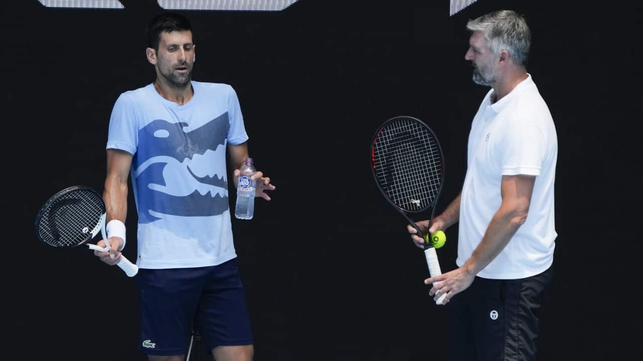 Serbia's Novak Djokovic talks with coach Goran Ivanisevic during a practice session ahead of the Australian Open tennis championship in Melbourne, Australia
